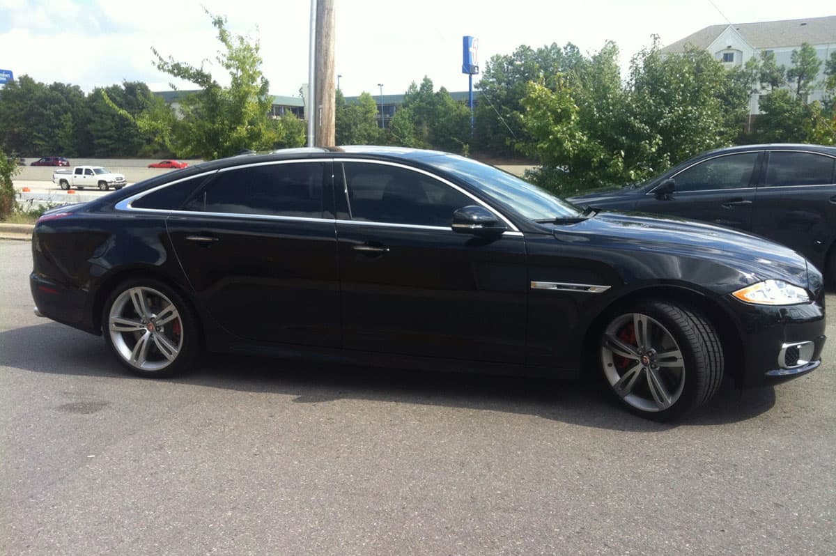 Car with professionally installed dark window tint by D&D Sun Control